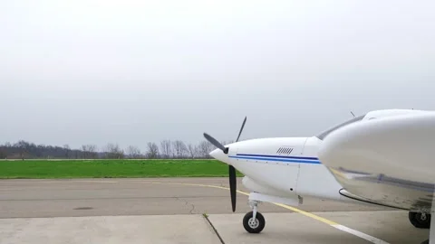 Single engine propeller airplane is standing in front of an airstrip Stock Footage 239070163