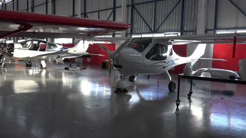 Single engine propeller airplanes parked inside closed aircraft hangar Stock Footage 340483044