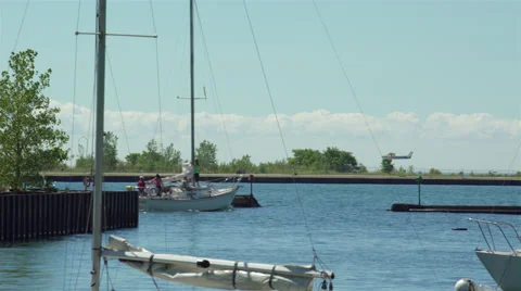 Single engine propeller plane landing at airport by the lake and marina. 4K U Stock Footage 53763940