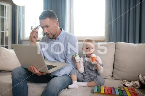 Single Father Looking Serious Working From Home