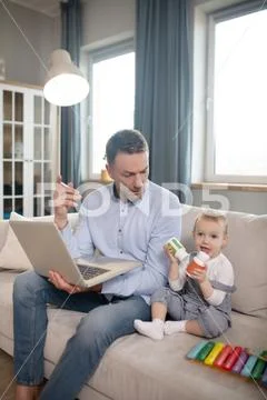 Single Father Spending His Time Working From Home And Taking Care About His