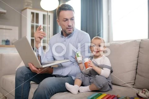 Single Father Spending His Time Working From Home