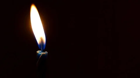 Single festive candle burns in the dark 스톡 동영상 82370833