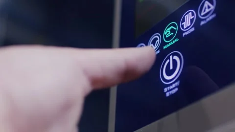 A single finger moves slowly towards an illuminated touch panel and finally pres Stock Footage 341294701