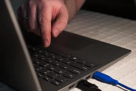 Single finger press button on laptop keyboard.Hand on laptop keyboard Stock Photos