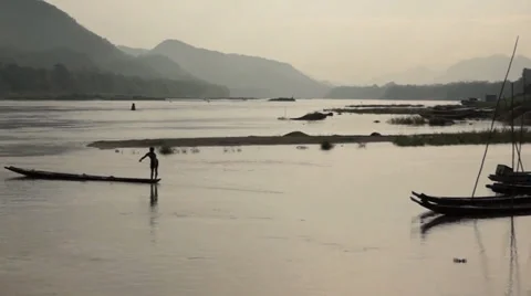 A single fisherman on  the  Mekong River in Laos. Stock Footage 34181553