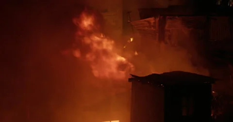 Single flame from shag in Intense fire inferno in poor settlement Video stock 65968801