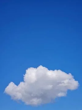 Single fluffy cloud Single fluffy cloud on blue sky background with copy s... Stock Photos