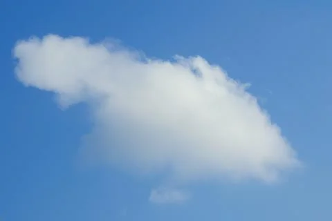 Single Fluffy White Cloud in Blue Sky Фото