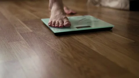 Single Foot Stepping Onto Smart Glass Scale on Wood Floor 스톡 동영상 340219801