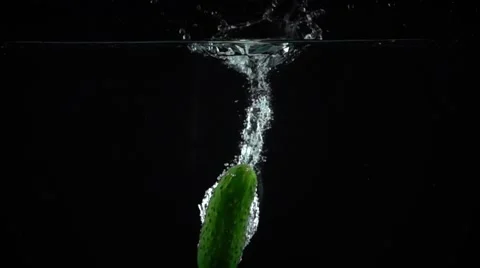 Single fresh green cucumber falling down in water, super slow motion shot Stock Footage 60374384