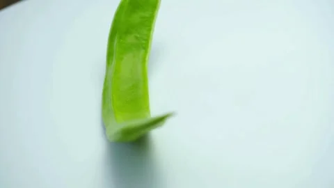 A single fresh green sword bean rotates on white Stock Footage 333810798