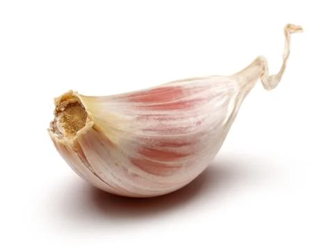 Single garlic clove isolated on white Stock Photos