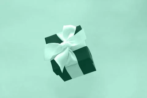Single gift box toned in mint color,trendy green colour wallpaper Stock Photos