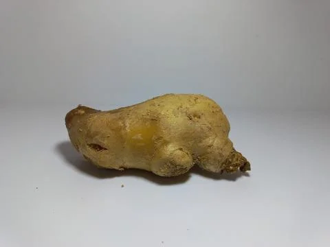 Single Ginger Root on White Surface. Foto stock