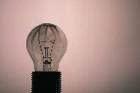 Single glass bulb mounted in socket with smoke inside Stock Photos