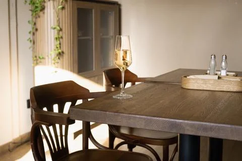 Single glass of wine on table for one person dining Stock Photos