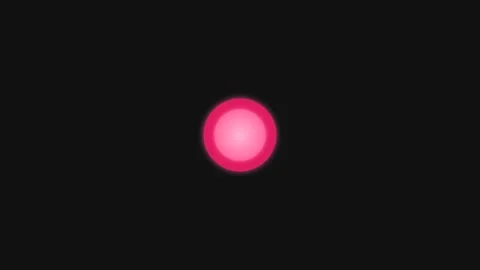 A single glowing pink circular orb centered against a deep black background Stock Footage 335117489