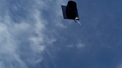Single graduation cap flying in the air. Virtual graduation, social distancing, Stock Footage 130034555