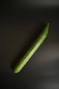 Single Green Cucumber on a Black Background Stock Photos