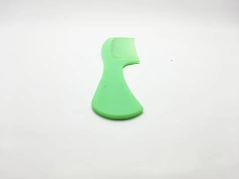 Single green plastic comb isolated on a white surface for hair styling Stock Photos
