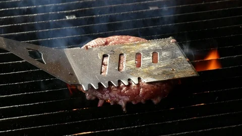 Single hamburger is cooking on the grill Video stock 98396206