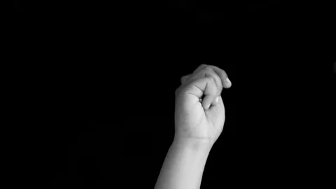 Single hand coming up and showing a bunch of safety pins/brooch isolated Stock Footage 117793181
