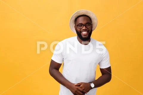 Single handsome muscular Black man with shaved head, folded arms and cheerful Stock Photos
