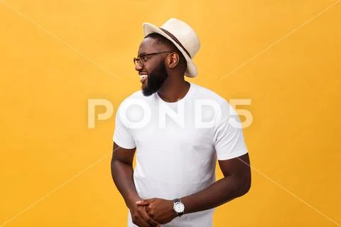 Single handsome muscular Black man with shaved head, folded arms and cheerful Stock Photos