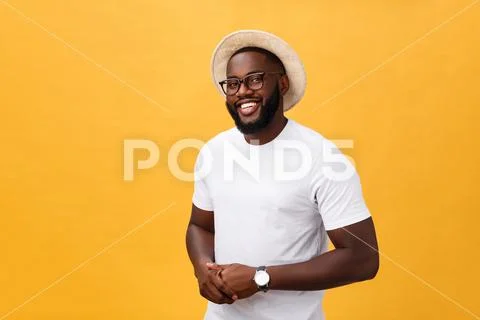 Single handsome muscular Black man with shaved head, folded arms and cheerful Stock Photos