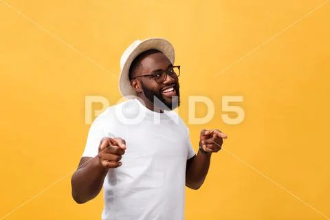 Single handsome muscular Black man with shaved head, folded arms and cheerful Stock Photos
