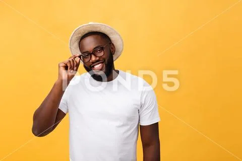 Single handsome muscular Black man with shaved head, folded arms and cheerful Stock Photos