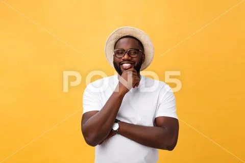 Single handsome muscular Black man with shaved head, folded arms and cheerful Stock Photos