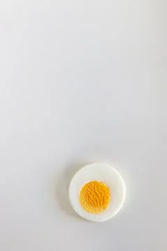 Single hard boiled egg slice on white background. Fotos Stock