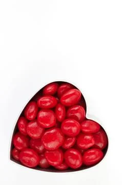 Single heart with candy on white Stock Photos