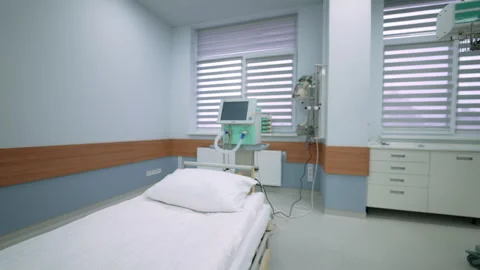 Single hospital bed with ventilator and monitor in ICU ward Stock Footage 332044512