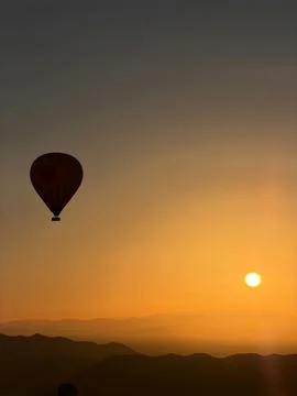 Single Hot Air Balloon Silhouette a Vibrant Orange Sunrise Sky in Morocco Stock Photos