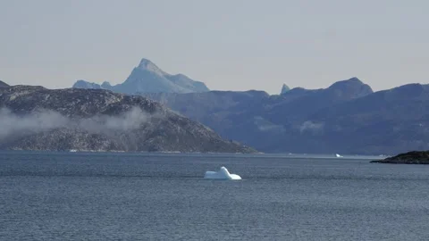 Single Iceberg Floating Before Rugged Mountains Near Nuuk Greenland Stock Footage 345526705