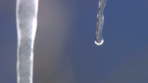 A Single Icicle Melts Against a Blue BacKground Stock-Footage 35361665