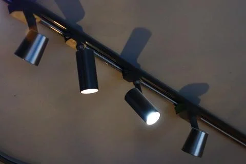 A single image showing three spotlight lights hung from a ceiling, often used in Stock Photos