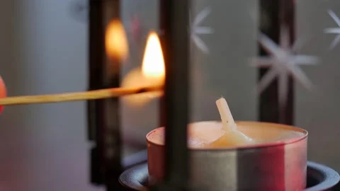Single Isolated candle burning.  paraffin candle with yellow shades burns in box Stock Footage 144032235
