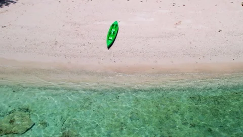 Single Kayak on the Tranquil Shores of a Pristine Beach, Captured from the Air Stock Footage 273453309