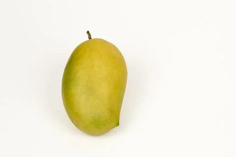 Single Kesar mango on white Foto stock