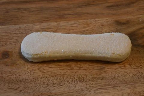 Single Ladyfinger Biscuit on Table Minimal Food Concept Copy Space Фото