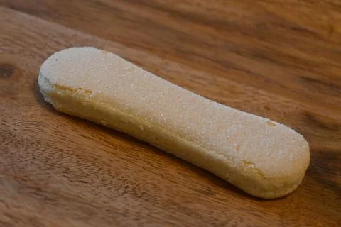 Single Ladyfinger Biscuit on Table Minimal Food Concept Copy Space Fotos de archivo