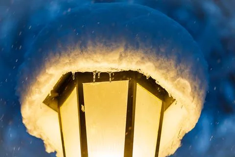 A single lantern is covered with a snowdrift. Stock Photos