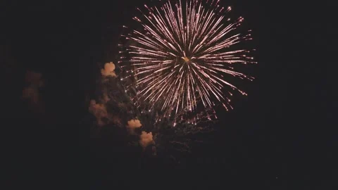 Single large firework rocket rising high and bursting brightly in dark night sky Stock Footage 340632804