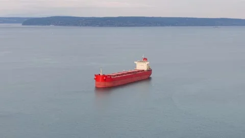 A single large red barge in the middle of Commencement Bay near Tacoma port. Video stock 324694218
