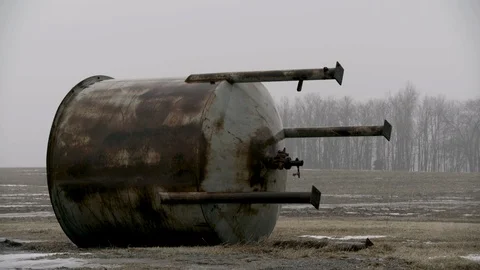 Single Large Water container junked in farm field winter fog Frame Left Stock Footage 89945138