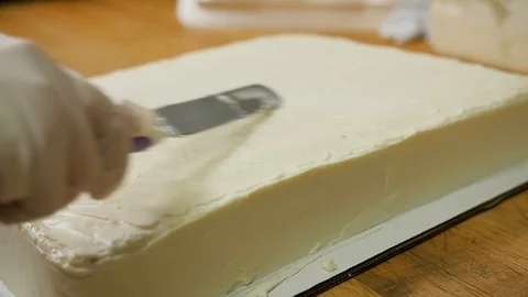 Single layer vanilla cake getting crisscross icing Video stock 94240749